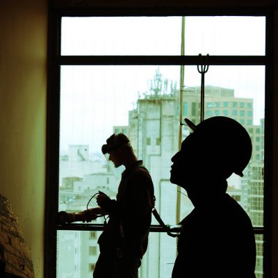 Men with powertools on building site with hard hats